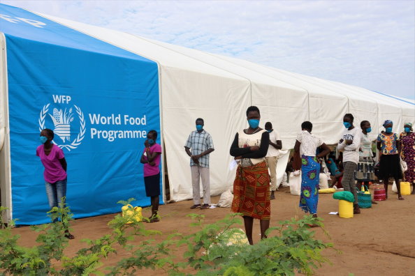 Photo: WFP/ Photogallery, Refugees wait to collect food at a centre in Kakuma camps