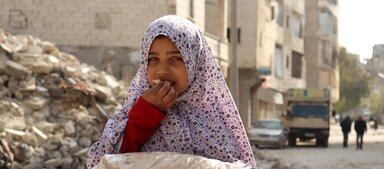 a girl eating bread