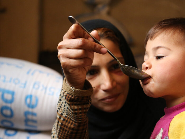 Syrian mother feeding child
