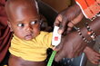 A chid is checked for malnutrition at the WFP-supported Tchiworou Health Center, in Chad. The red measurement indicates severe malnutrition. Photo: WFP/Amadou Baraze