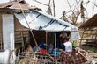 A WFP employee speaks to a Cyclone Mocha survivor in Sittwe, Myanmar. Su Myat Yadanar