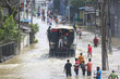 A truck makes its way down a flooded road in Sri Lanka