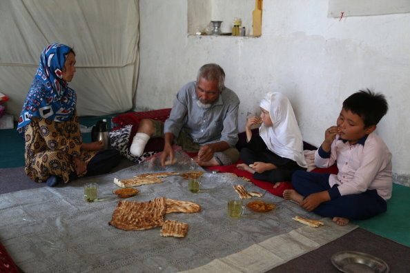 Photo: WFP/Arete. 2021年9月15日、アフガニスタンのマザールにある自宅で食事をする一家。国連WFPは、国内避難民や弱い立場にある家族に食料や現金の支援を行っています。