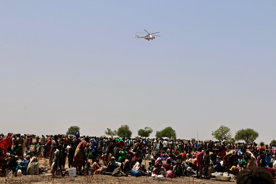 Helicopter above large group of people