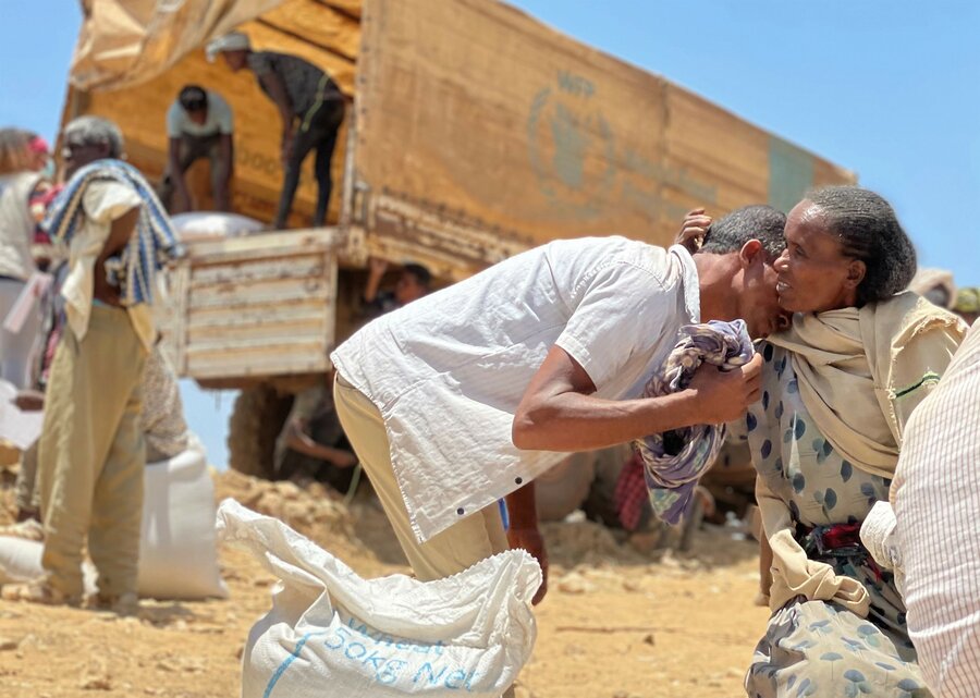 Community members embrace at the first WFP food distribution in Adi Millen, a rural village in northwestern Tigray. Photo: WFP/Claire Nevill