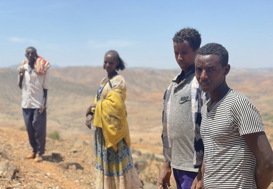 Aster and her husband Tesfay and two of their sons walk back to a temporary shelter where they have been staying since their home was set ablaze. Photo: WFP/Claire Nevill