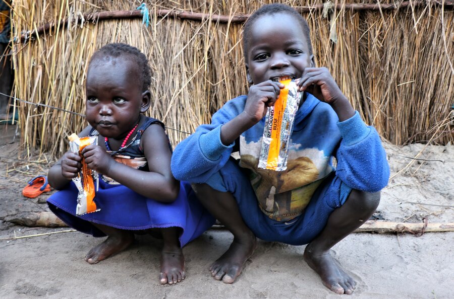 Masaba and Nyasebit, two of Chung's children, eat nutrition supplements provided by WFP to treat malnutrition in children under 5. Photo: WFP/Eulalia Berlanga