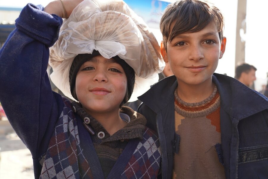 Two boys collect fresh bread for their families at a bakery rehabilitated by WFP in Aleppo. Photo: WFP/Jessica Lawson
