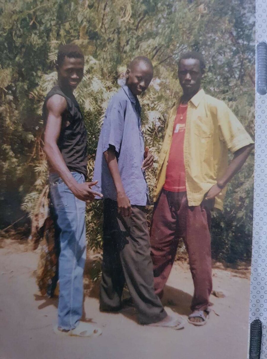 Figure 1- Elijah (center) with friends in Kakuma