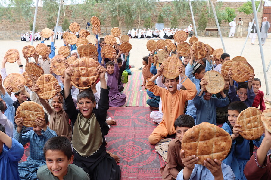 Children at school in Nangahar province holding up Bread +. Photo: WFP/Sadeq Naseri