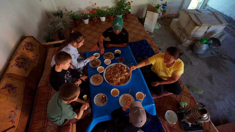 Baktygul's large family enjoys a meal. Their income is growing thanks to herbal farming. Photo: WFP