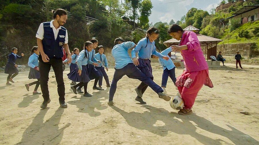 WFP Programme Officer Akira Kaneko (L) faces stiff competition from these primary school kids at Shree Kakani Ganesh Primary School, in central Nepal. Photo: WFP/Srawan Shrestha