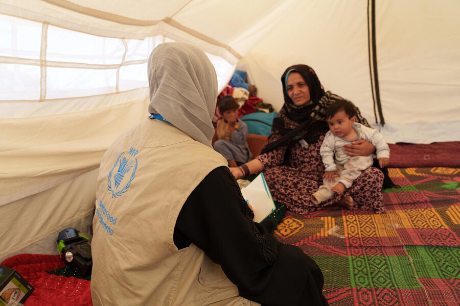 Grandmother Ziba speaks with a WFP food monitor. One of her daughters died in the quake, leaving two small grandchildren in Ziba's care. Photo: WFP/Hasib Hazinyar