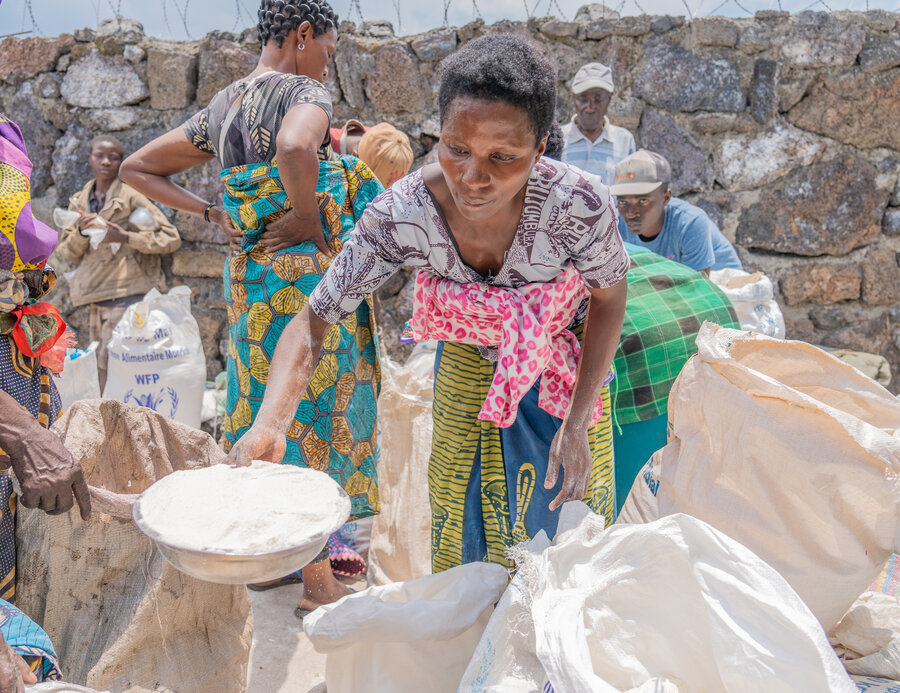 A woman putting food into a bag