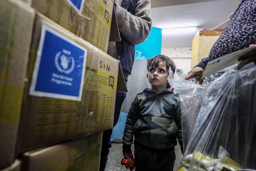 A boy looks at boxes at a WFP distribution in Gaza Photo: Mostafa Ghroz