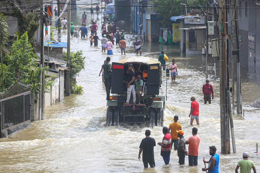 A truck makes its way down a flooded road in Sri Lanka