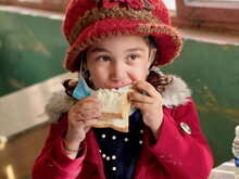 Children in Qadissiya, southern Iraq receive a healthy meal of fresh bread, cheese, fruit and water on the days they attend school. Photo: WFP/Heyad Musa